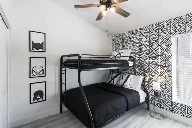 a bedroom with a bed and a chandelier