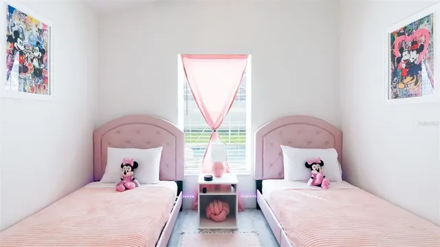 a bedroom with furniture and a large window