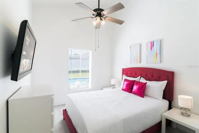 a bedroom with a bed a couch and a window