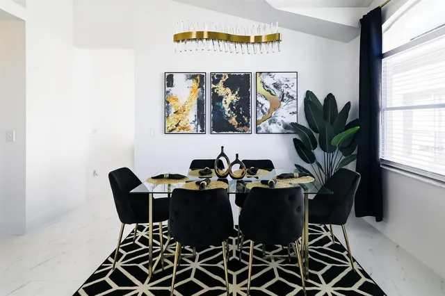 a view of a workspace with furniture and window