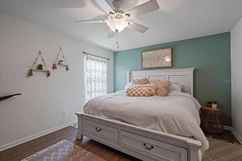3271 Titanic Circle, Unit 39 Indialantic, FL 32903 - Photo 37 of 60 a bedroom with a bed and a chandelier