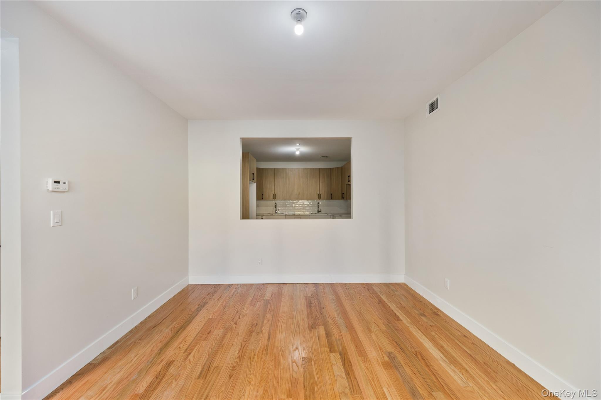 17 Lazer Court, Unit 103 Spring Valley, NY 10977 - Photo 12 of 36 a view of a room with wooden floor and white walls