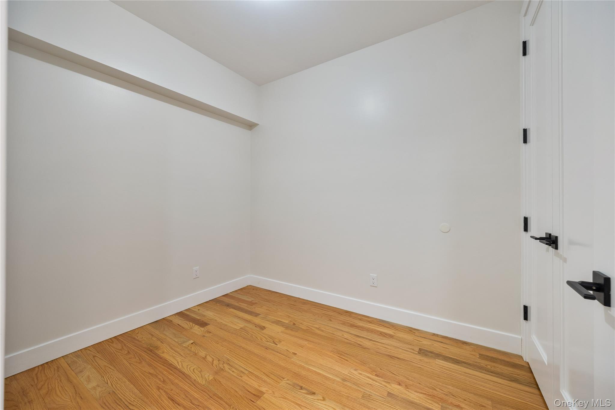 17 Lazer Court, Unit 103 Spring Valley, NY 10977 - Photo 25 of 36 a view of a room with wooden floor and white walls