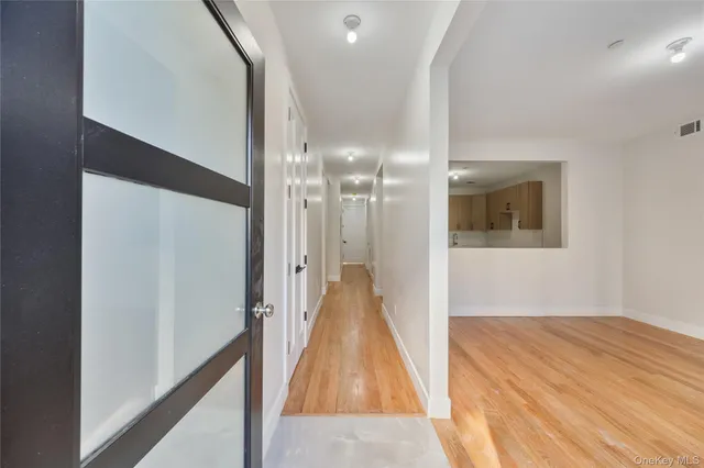 a view of a room with wooden floor and staircase