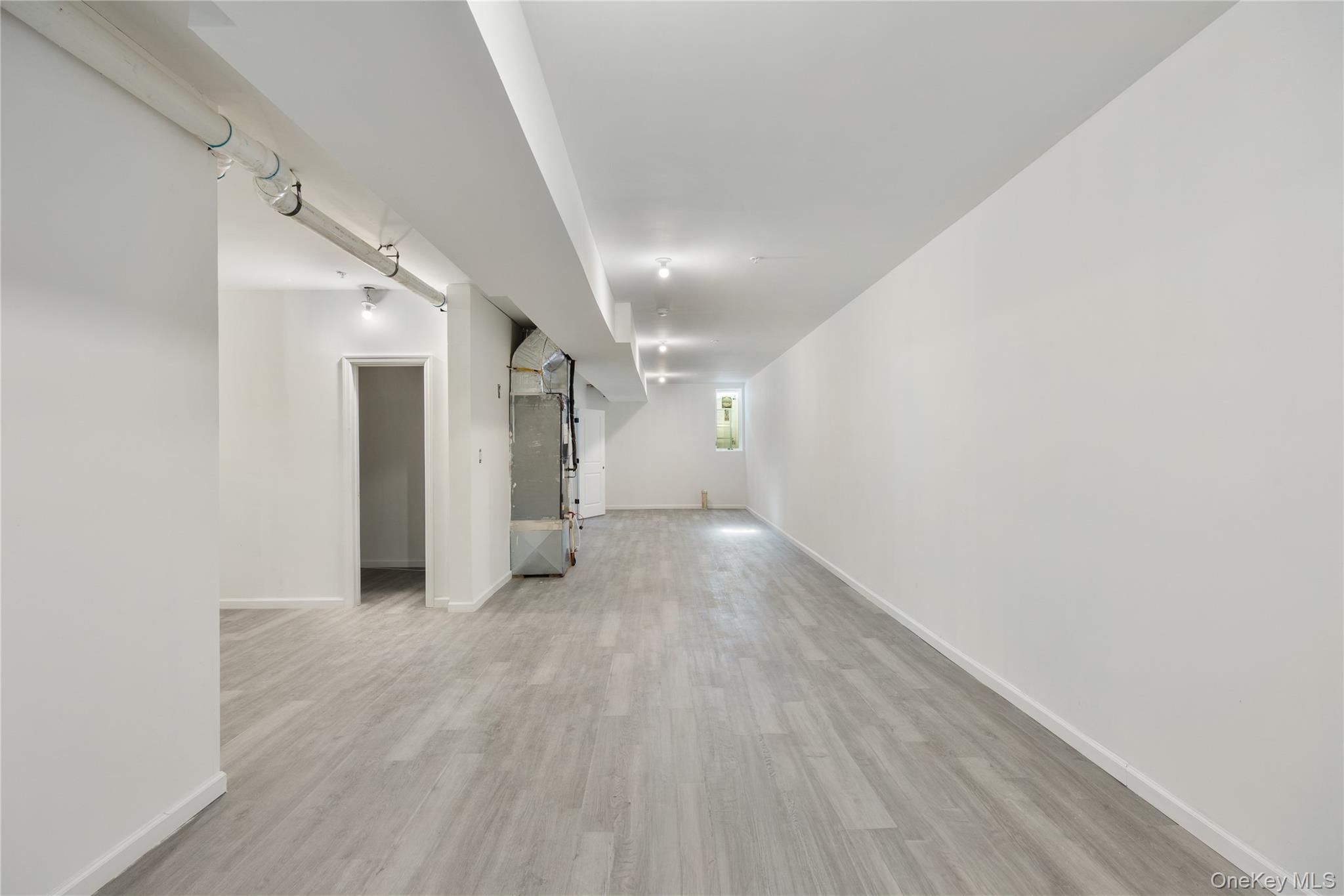 17 Lazer Court, Unit 103 Spring Valley, NY 10977 - Photo 34 of 36 a view of a hallway with wooden floor