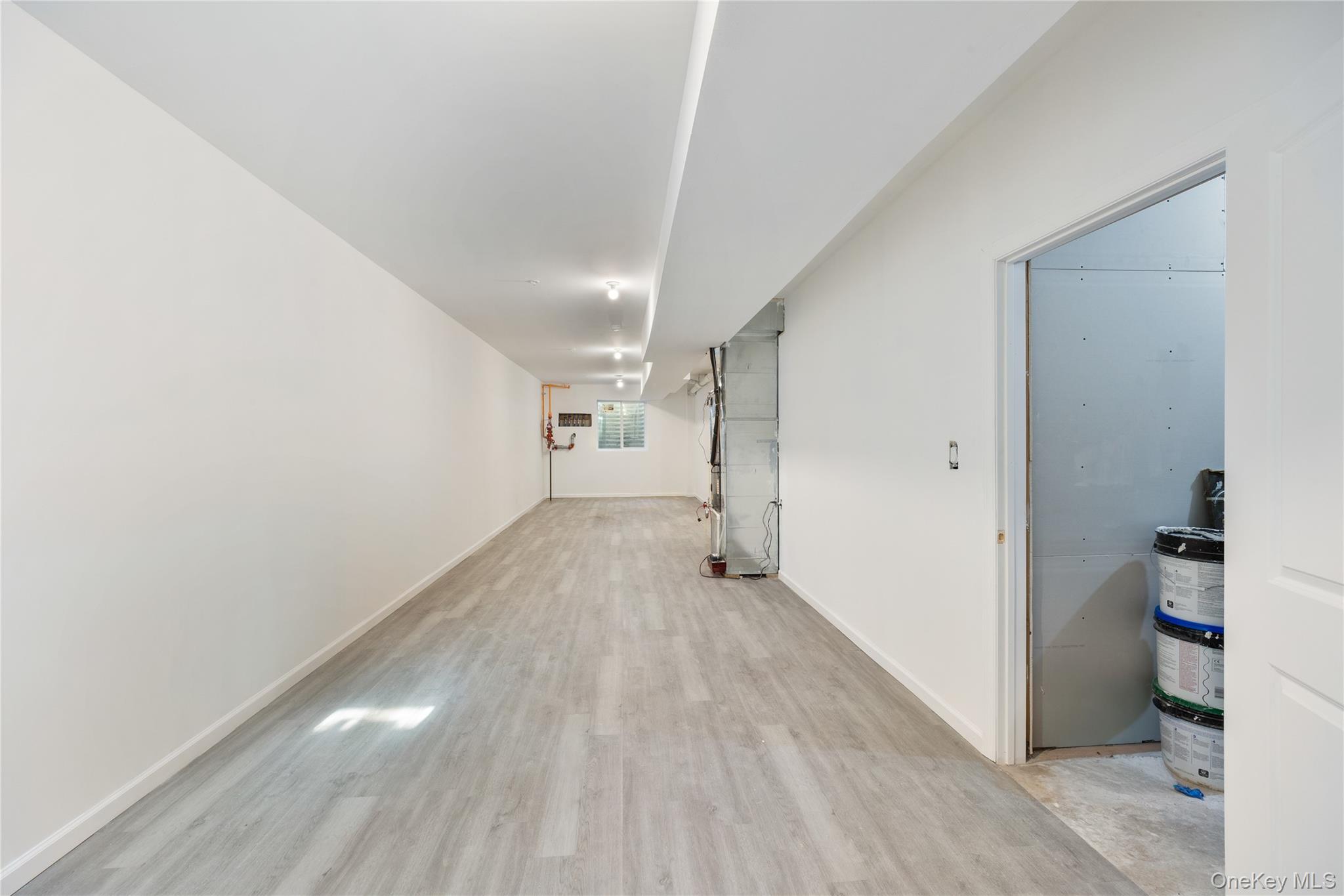 17 Lazer Court, Unit 103 Spring Valley, NY 10977 - Photo 35 of 36 a view of a hallway with wooden floor and entryway