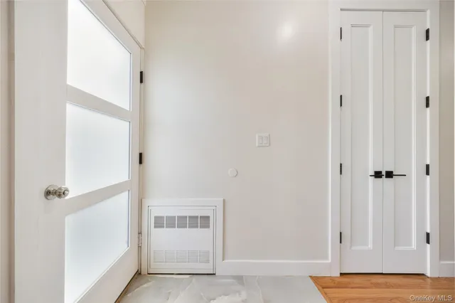 a view of a bedroom with wooden floor