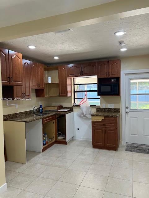 2820 Southwest 65th Avenue Miramar, FL 33023 - Photo 14 of 24 a large kitchen with stainless steel appliances granite countertop a stove sink and cabinets