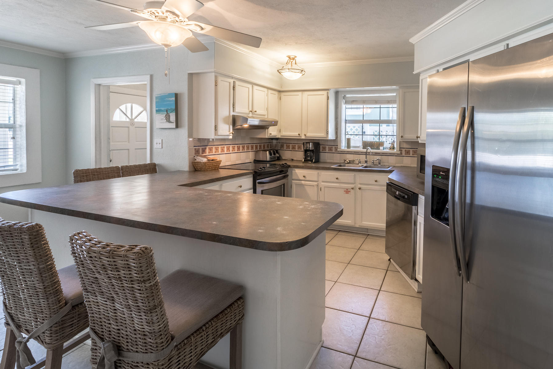 522 Defuniak Street, Unit 30A Santa Rosa Beach, FL 32459 - Photo 14 of 46 a kitchen with stainless steel appliances granite countertop a sink a stove and island