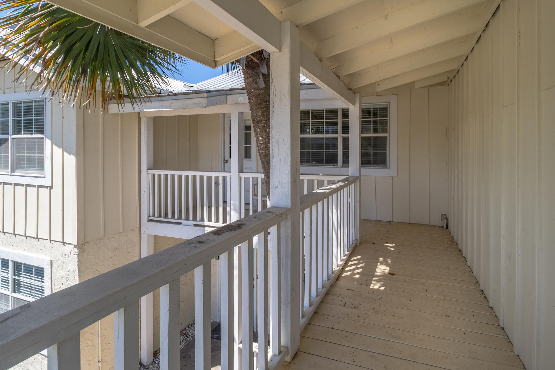 522 Defuniak Street, Unit 30A Santa Rosa Beach, FL 32459 - Photo 32 of 46 a porch with wooden floor and potted plants