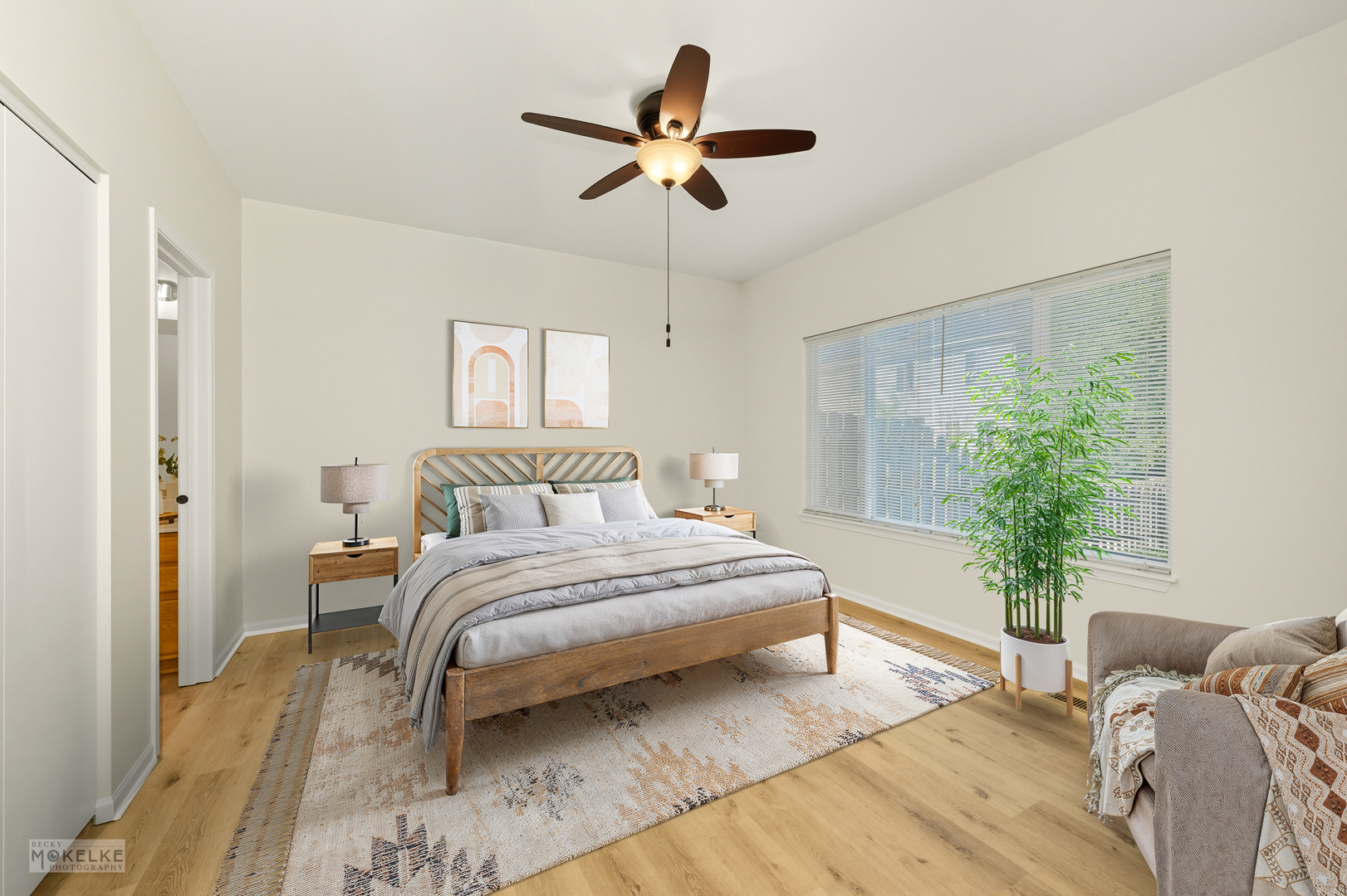2813 Hoffman Street Plano, IL 60545 - Photo 16 of 27 a spacious bedroom with a bed and a chandelier