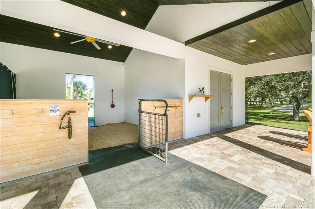2541 Southwest Trailside Path Stuart, FL 34997 - Photo 86 of 100 a spacious bedroom with a large bed and a large window