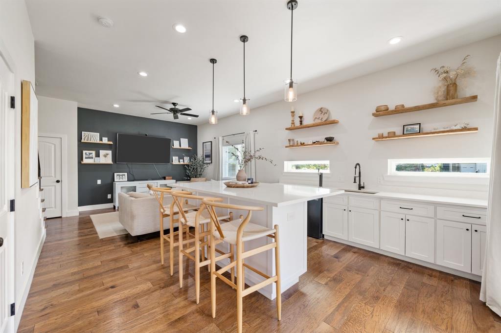 504 Main Street Roanoke, TX 76262 - Photo 14 of 40 a kitchen with kitchen island a large counter top space appliances and cabinets