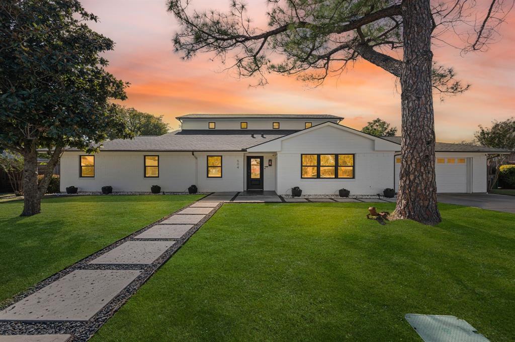 504 Main Street Roanoke, TX 76262 - Photo 2 of 40 a view of a yard in front of a house with a large tree