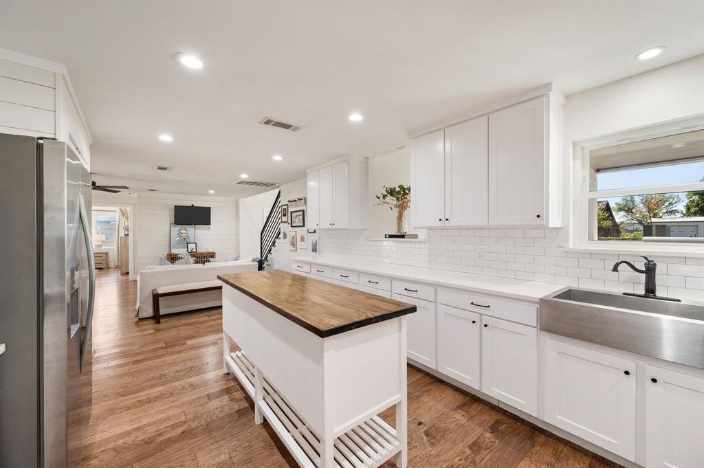504 Main Street Roanoke, TX 76262 - Photo 9 of 40 a kitchen with white cabinets sink and stainless steel appliances