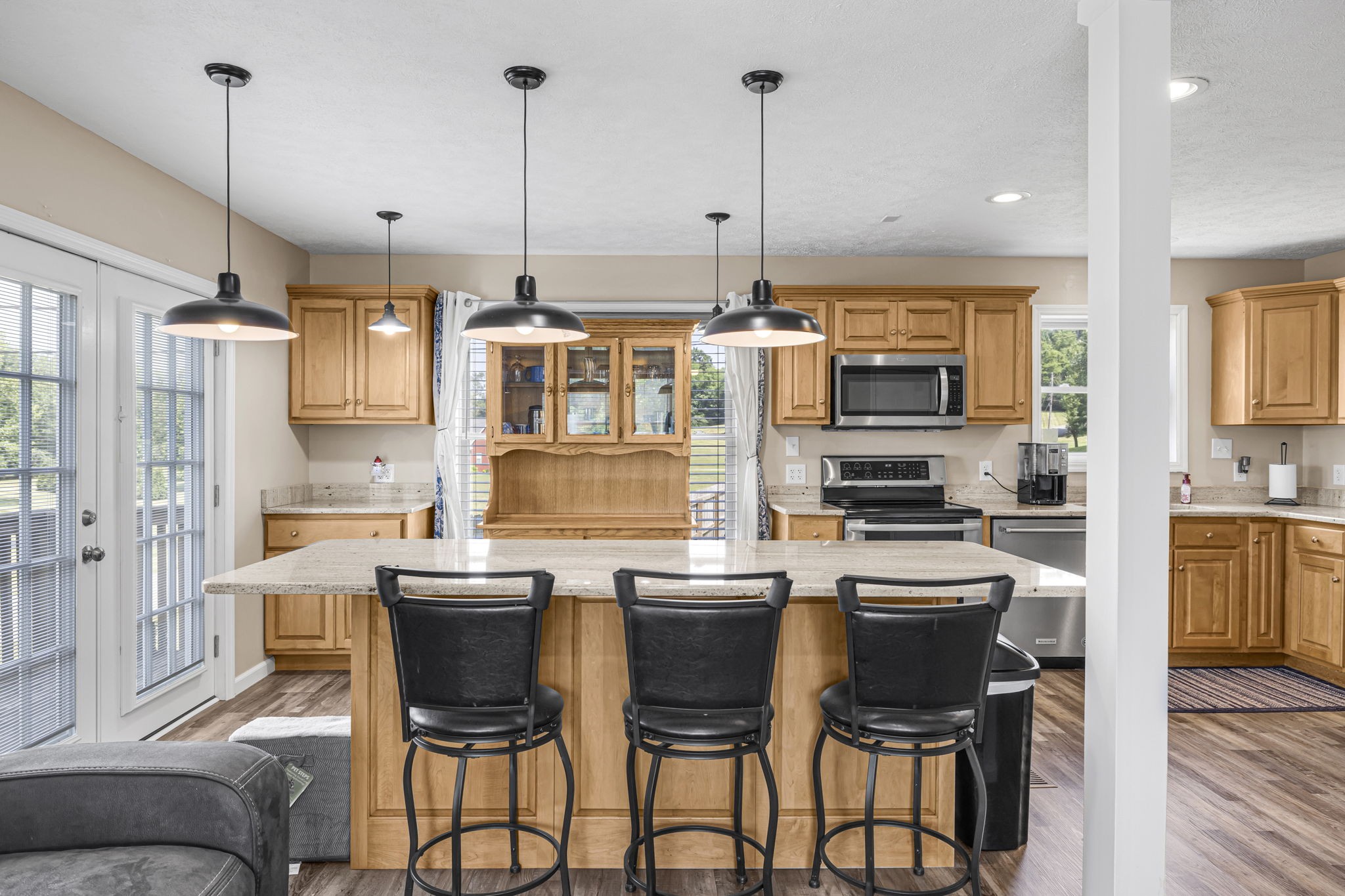670 Still Pond Road Columbia, TN 38401 - Photo 14 of 43 a kitchen with stainless steel appliances kitchen island granite countertop a stove a refrigerator a oven a sink with a dining table and chairs