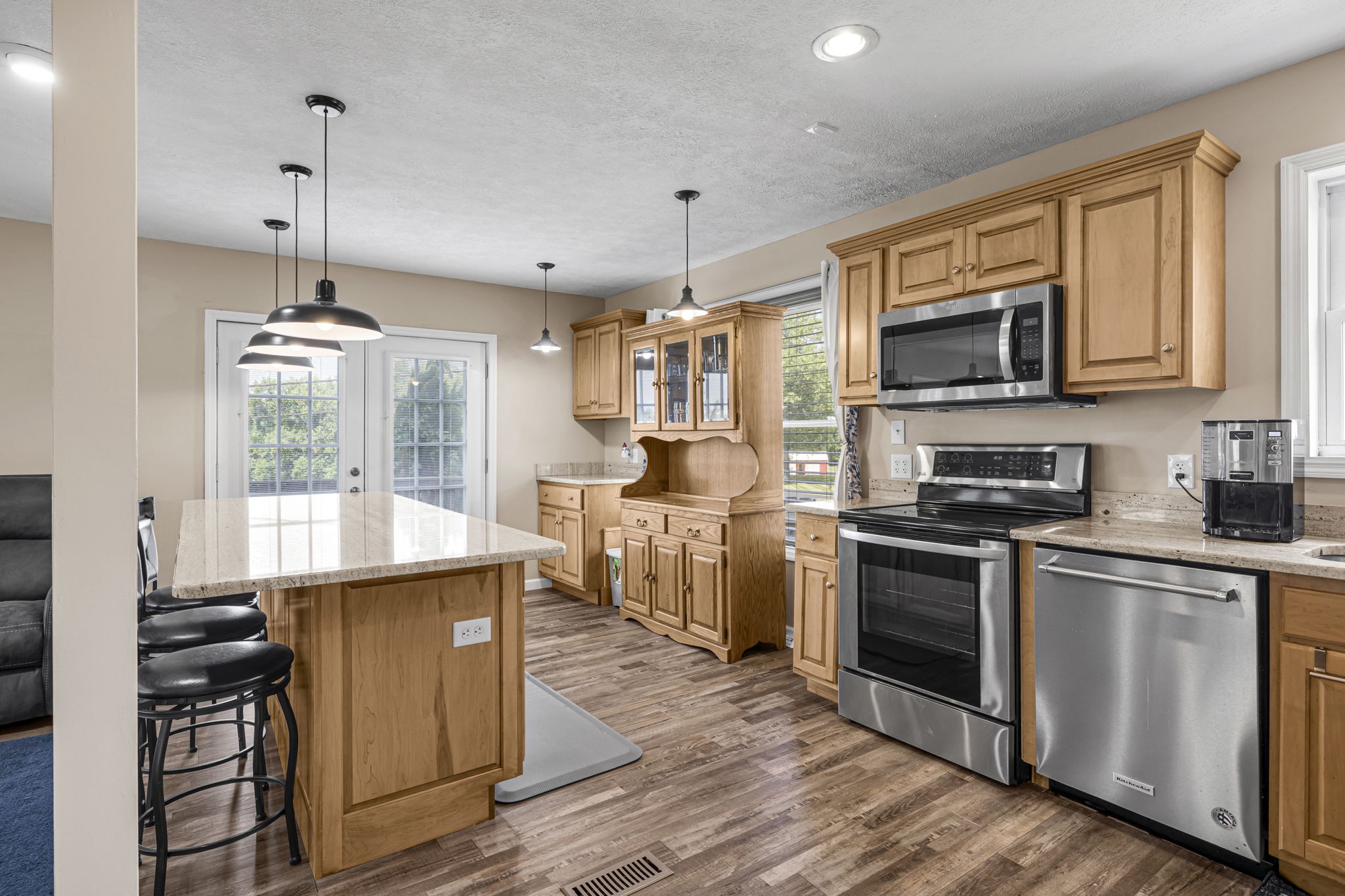 670 Still Pond Road Columbia, TN 38401 - Photo 15 of 43 a kitchen with stainless steel appliances granite countertop a stove top oven a sink dishwasher a refrigerator and a dining table with wooden floor