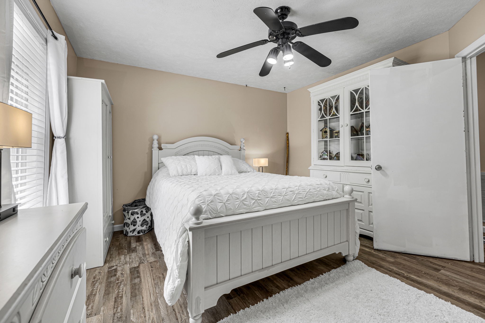 670 Still Pond Road Columbia, TN 38401 - Photo 21 of 43 a bedroom with a large bed and a chandelier