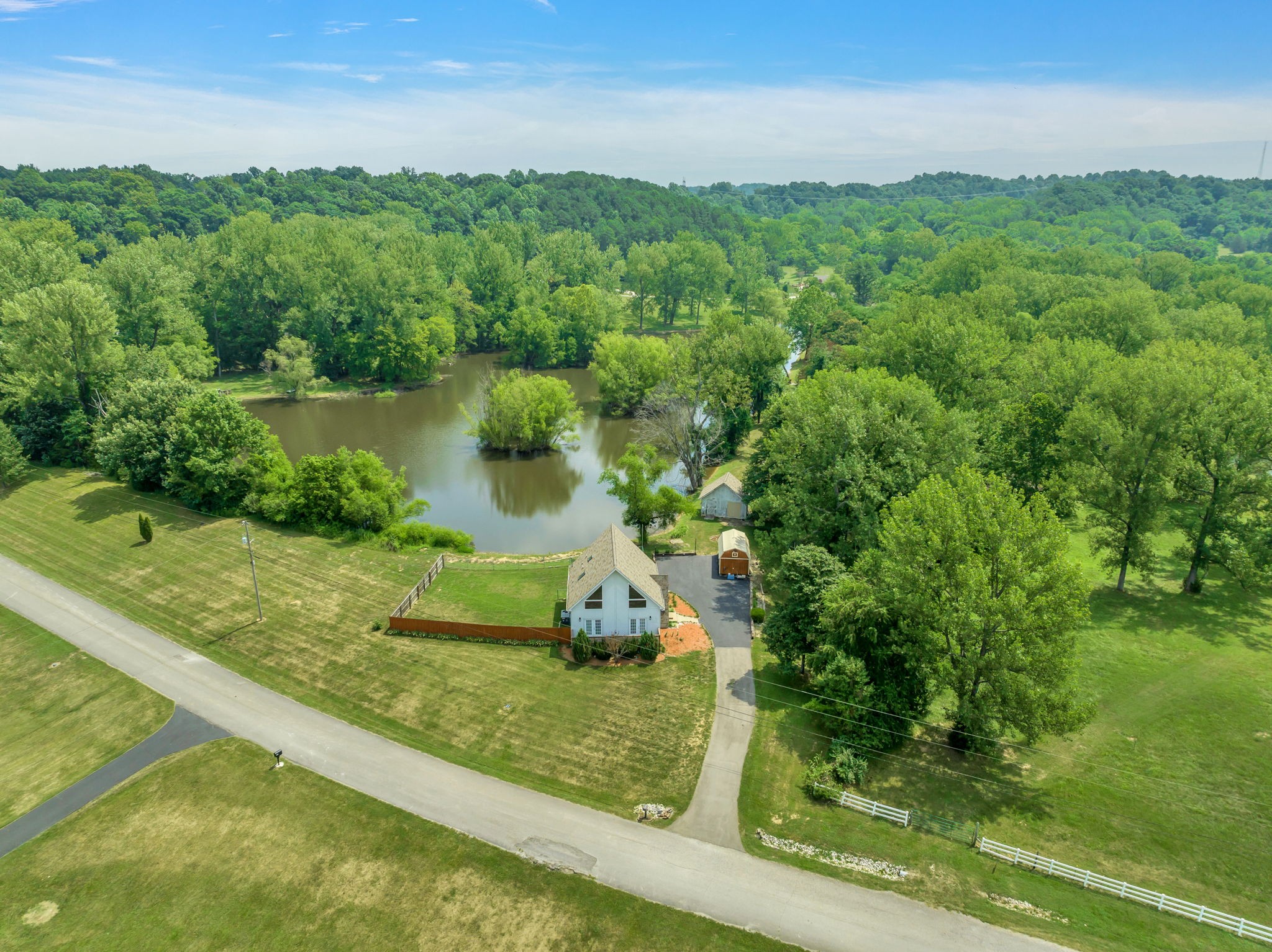 670 Still Pond Road Columbia, TN 38401 - Photo 3 of 43 a view of a garden with a lake