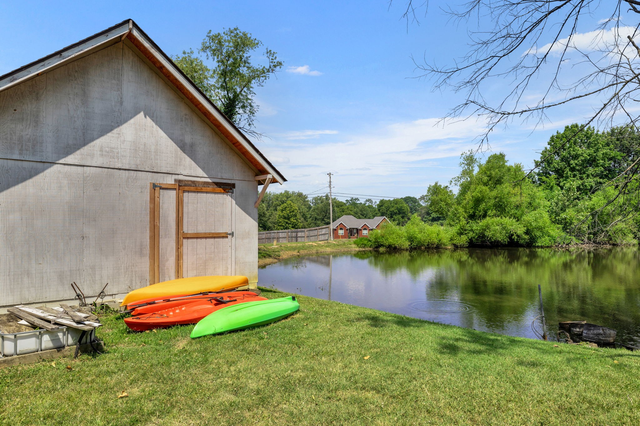 670 Still Pond Road Columbia, TN 38401 - Photo 34 of 43 a backyard of a house with lots of green space and lake view