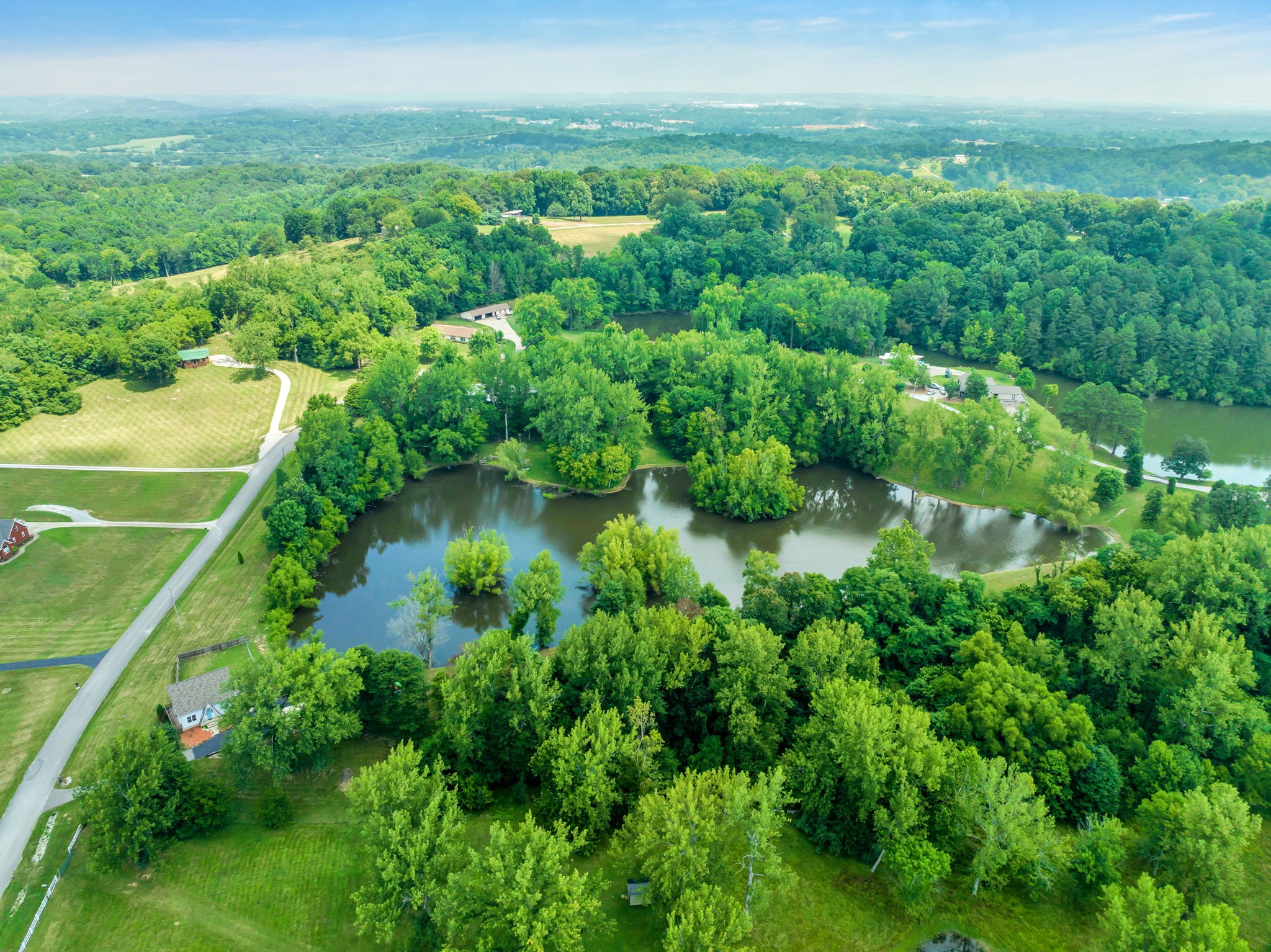 670 Still Pond Road Columbia, TN 38401 - Photo 43 of 43 a view of a garden with a lake