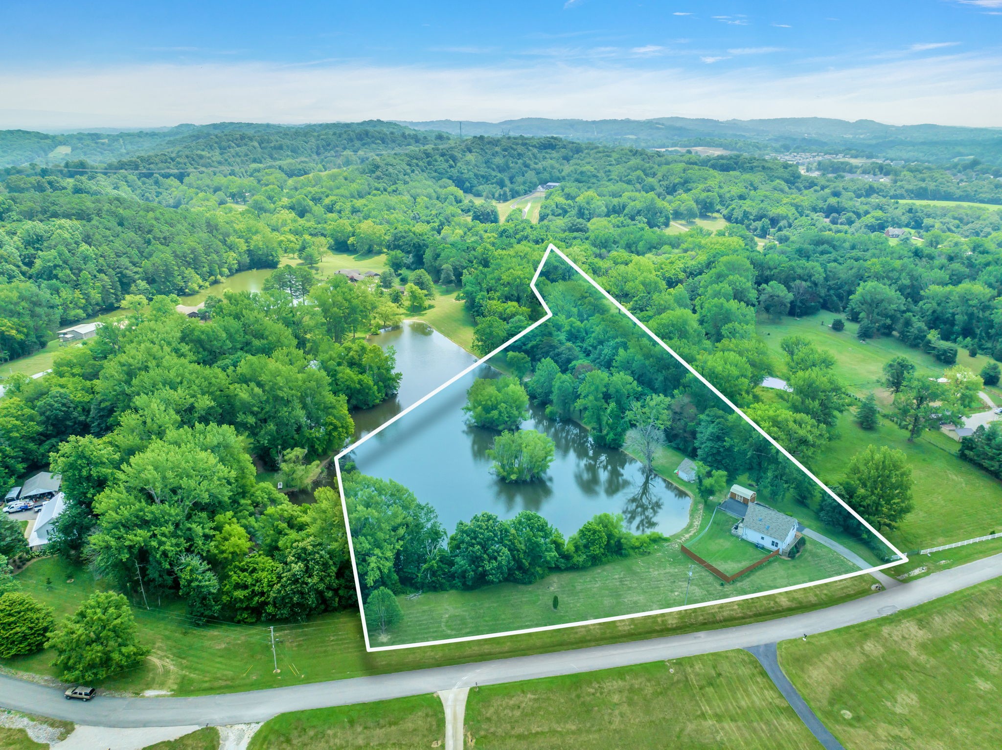 670 Still Pond Road Columbia, TN 38401 - Photo 5 of 43 a view of a lush green forest with a house