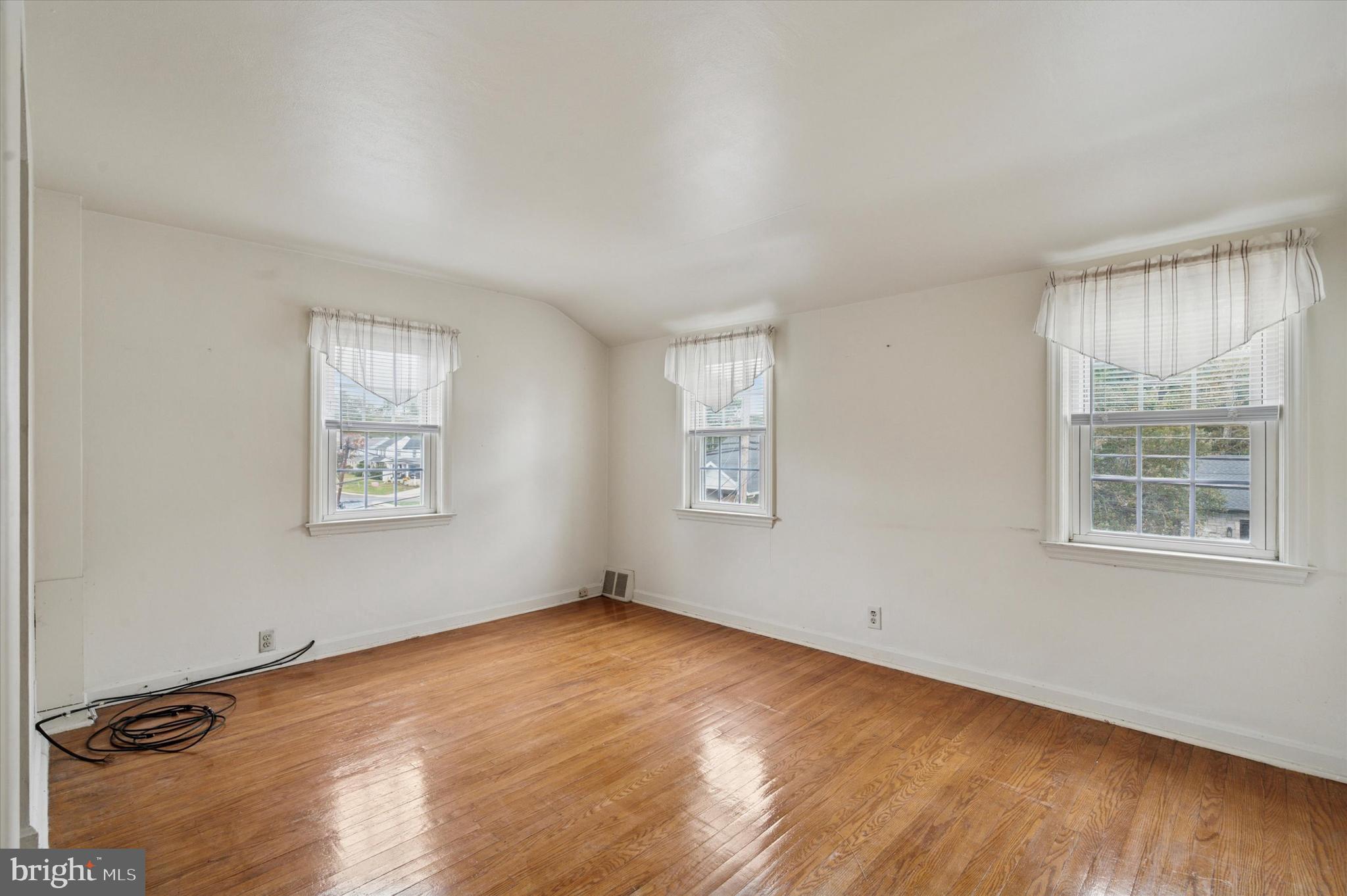 363 Holmes Road Holmes, PA 19043 - Photo 11 of 25 wooden floor in an empty room with a window