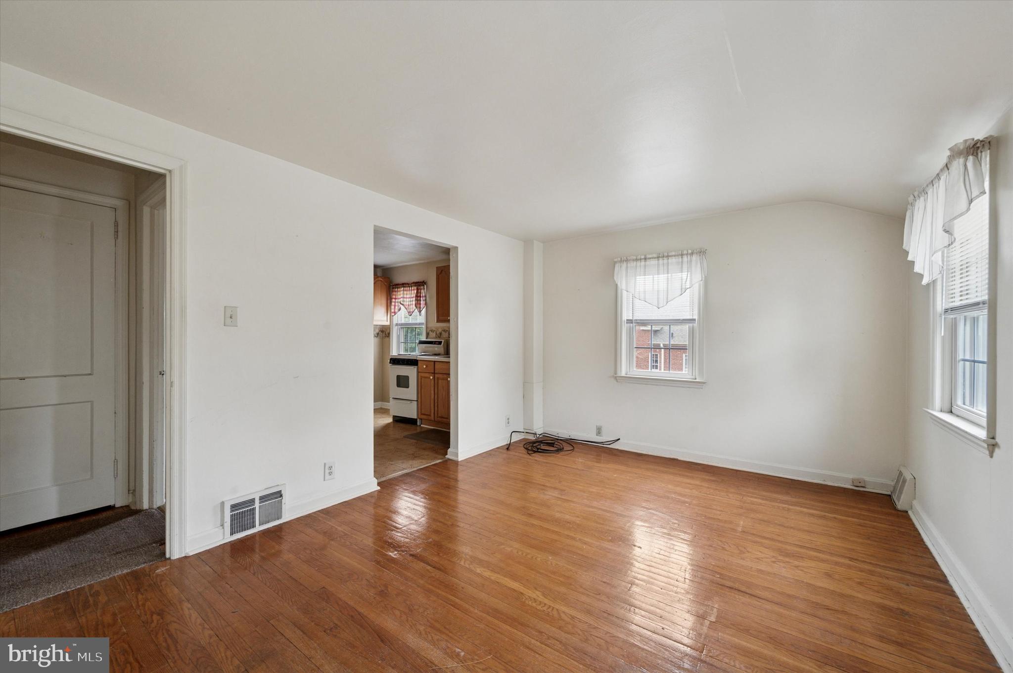 363 Holmes Road Holmes, PA 19043 - Photo 14 of 25 an empty room with wooden floor and windows