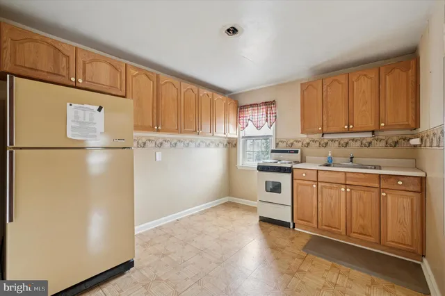 a kitchen with stainless steel appliances granite countertop a refrigerator sink and cabinets