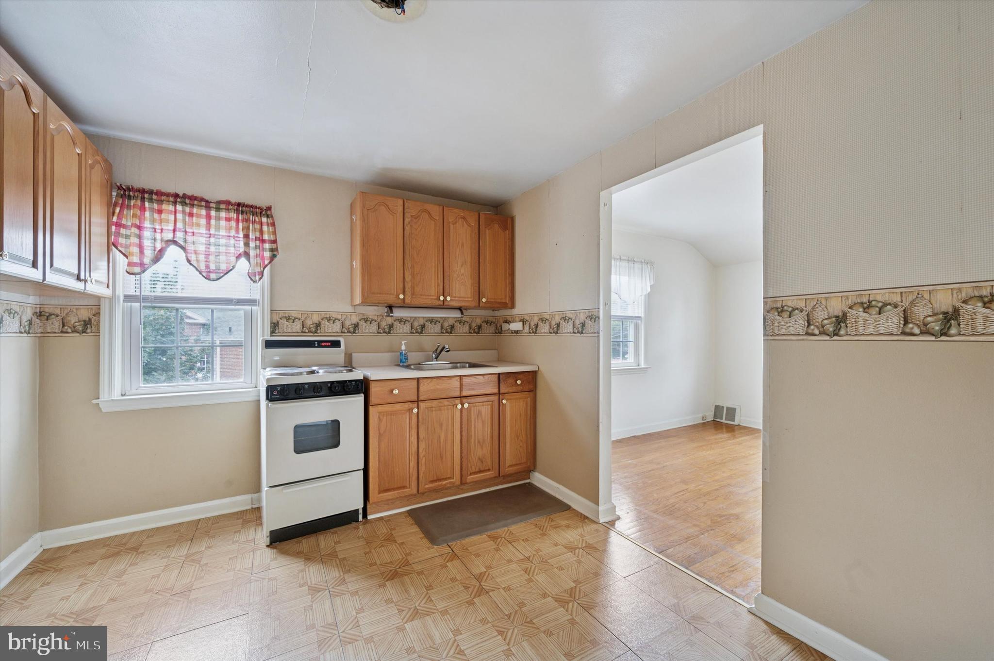 363 Holmes Road Holmes, PA 19043 - Photo 16 of 25 a kitchen with granite countertop a stove top oven sink and cabinets