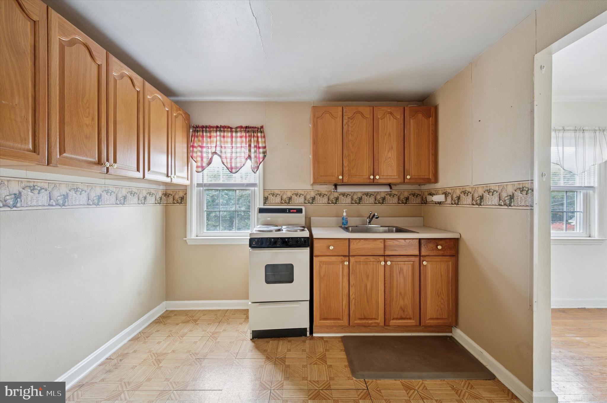 363 Holmes Road Holmes, PA 19043 - Photo 17 of 25 a kitchen with stainless steel appliances granite countertop a stove a sink and a microwave