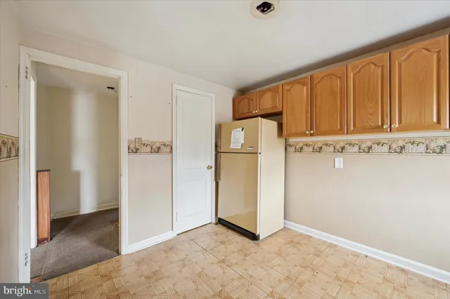 a view of cabinets with refrigerator in kitchen