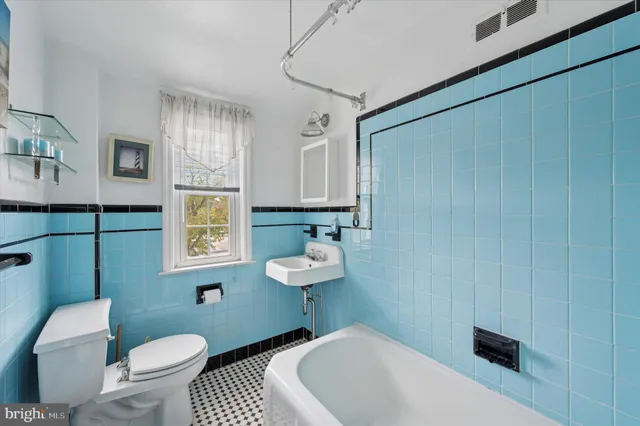 a bathroom with a sink a toilet a mirror and vanity