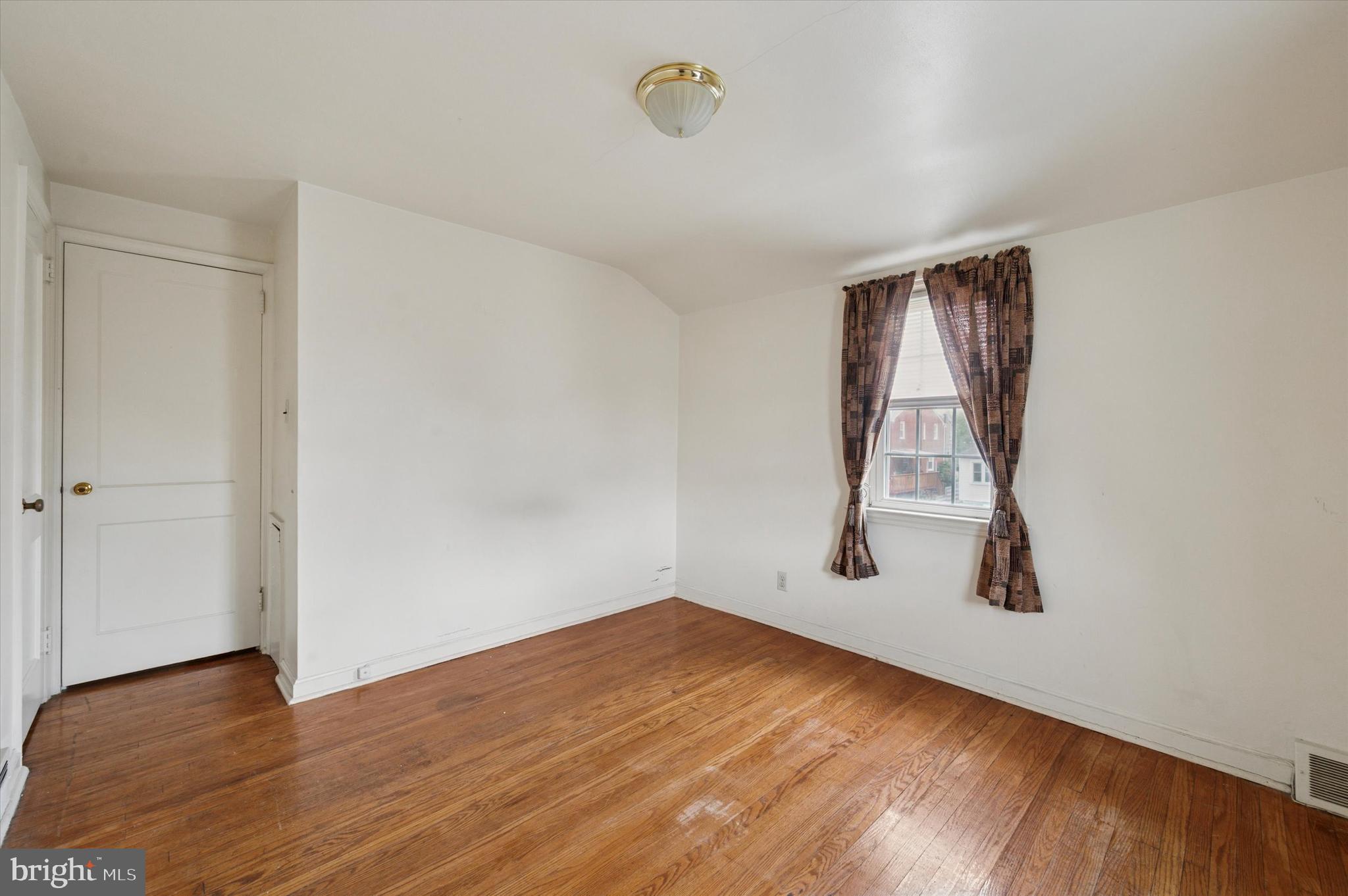 363 Holmes Road Holmes, PA 19043 - Photo 23 of 25 an empty room with wooden floor and windows