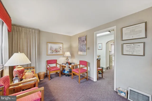 a living room with furniture and a baby crib
