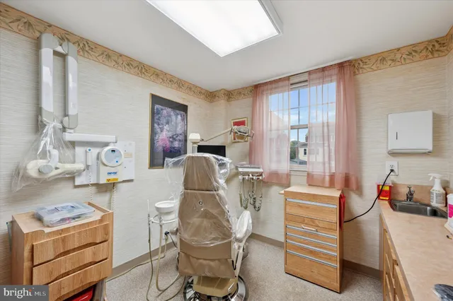 a living room with furniture a flat screen tv and a window