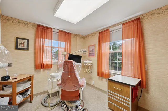 a living room with furniture a flat screen tv and a window