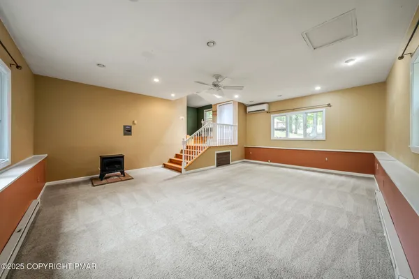 a view of a livingroom with a furniture and a ceiling fan