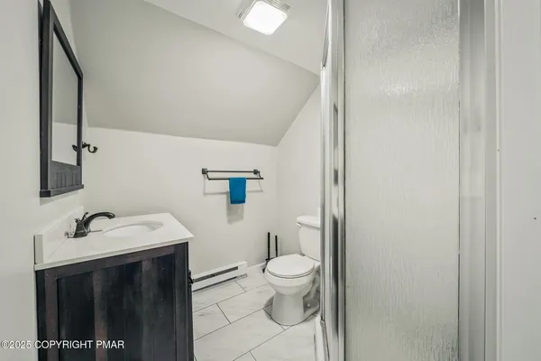 a bathroom with a sink toilet and mirror