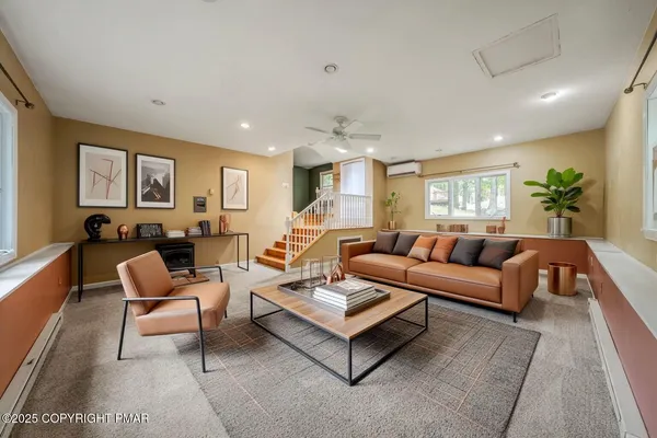 a living room with furniture or couch and a potted plant