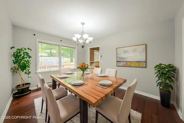 a view of a dining room with furniture window and wooden floor