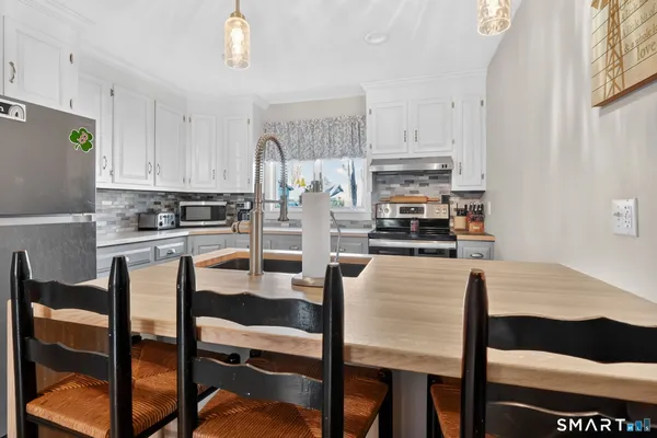 a utility room with sink dryer and washer