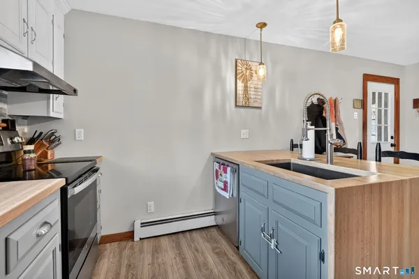 a kitchen with cabinets a sink appliances and a counter space