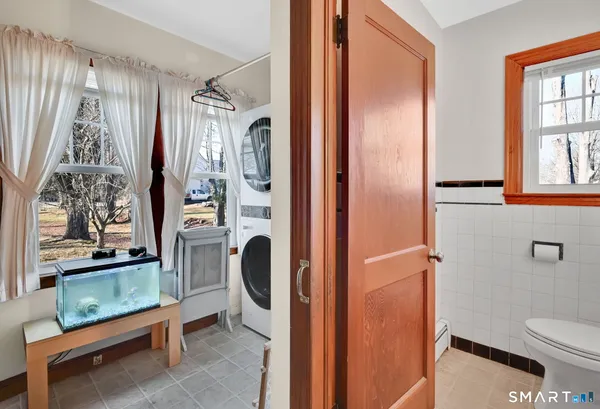 a bathroom with a sink a toilet and mirror