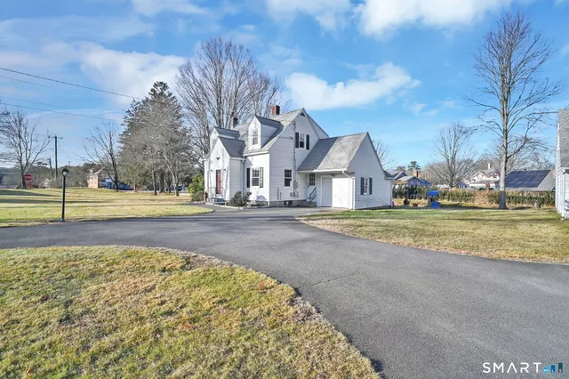 a swimming pool with outdoor seating and yard