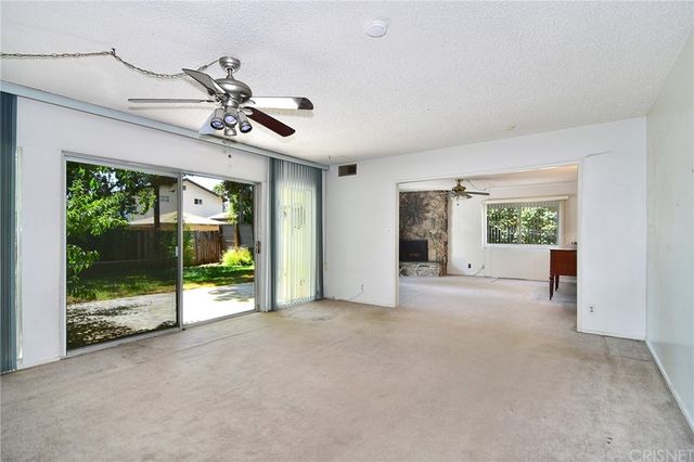 a view of an empty room with windows