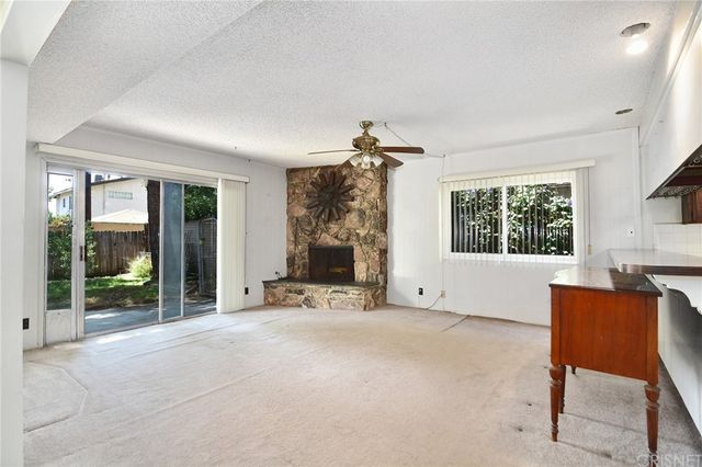 a view of a livingroom with furniture and a fireplace