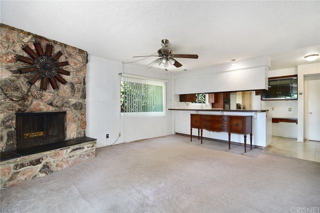 a view of a livingroom with furniture and a fireplace
