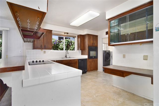 a kitchen with a sink stove and cabinets