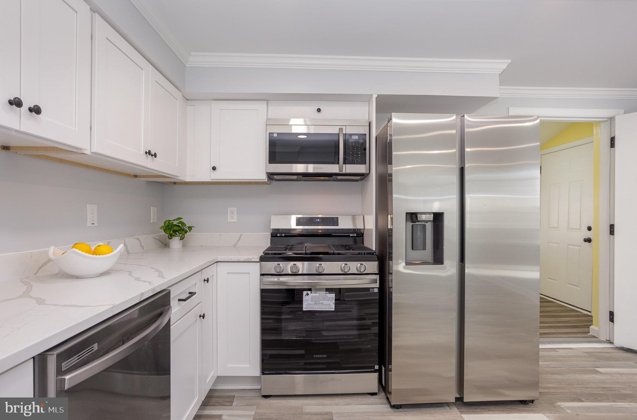 2070 Larkhall Road Dundalk, MD 21222 - Photo 9 of 26 a kitchen with a stainless steel appliances and cabinets